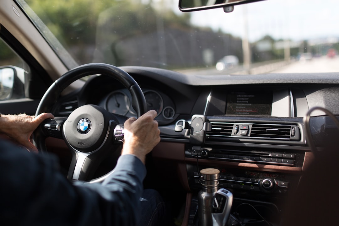 person-holding-bmw-steering-wheel-n0j15w4z0-m